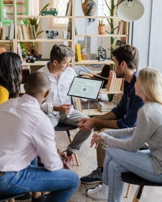 Businessman leading a presentation in loft office